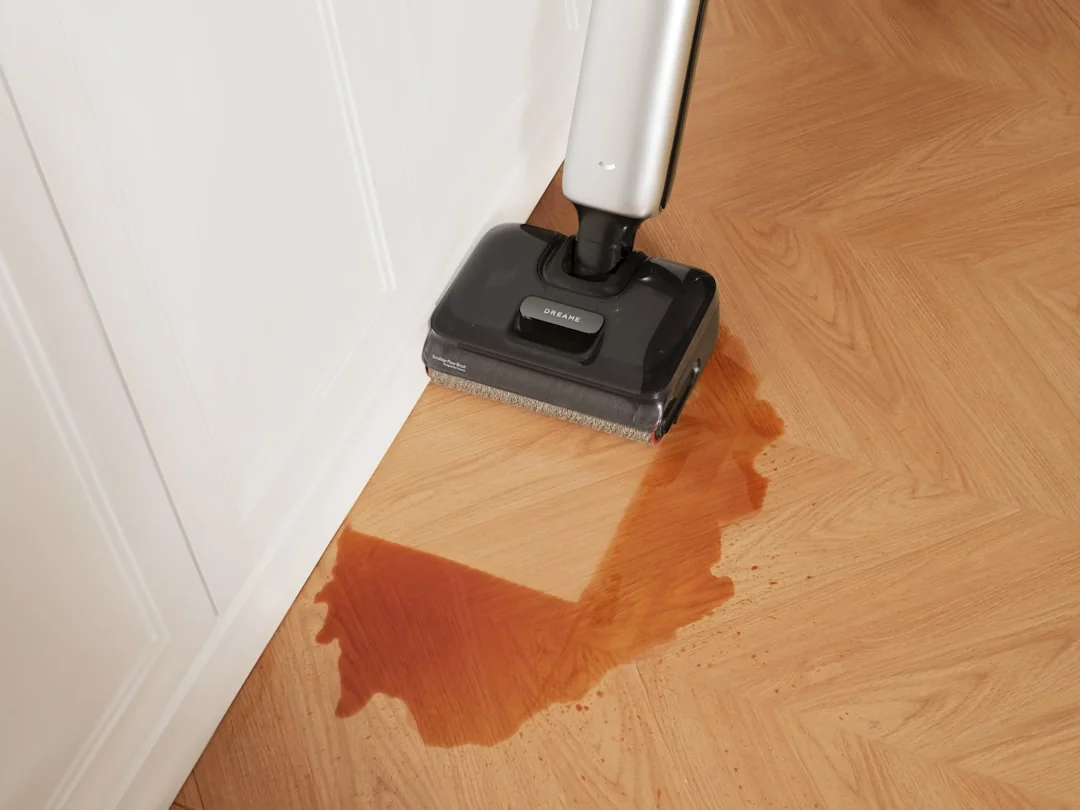 Person using spray bottle and cloth for cleaning a kitchen shelf, ensuring hygiene and cleanliness.